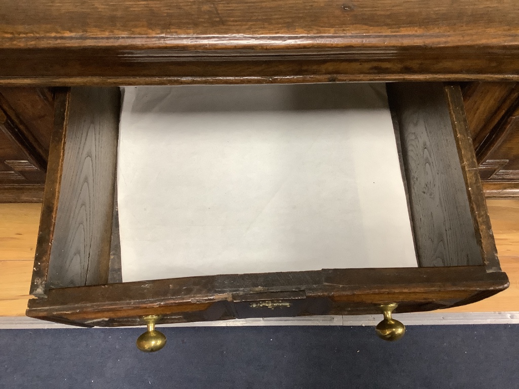 A Charles II oak dresser, fitted three drawers, with geometric mounted fronts